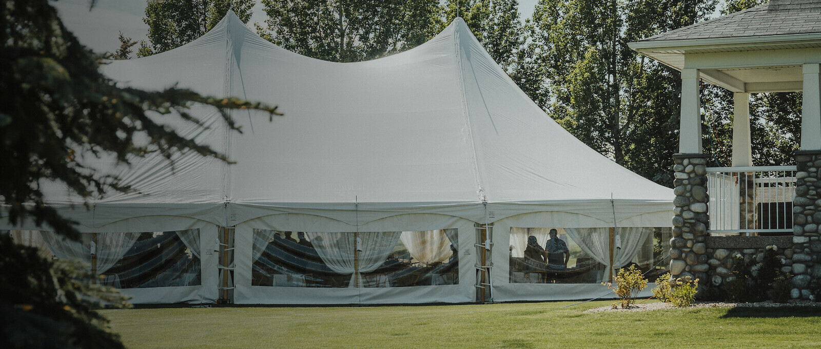 Pole tent in a backyard set up by Special Event Rentals for a backyard wedding