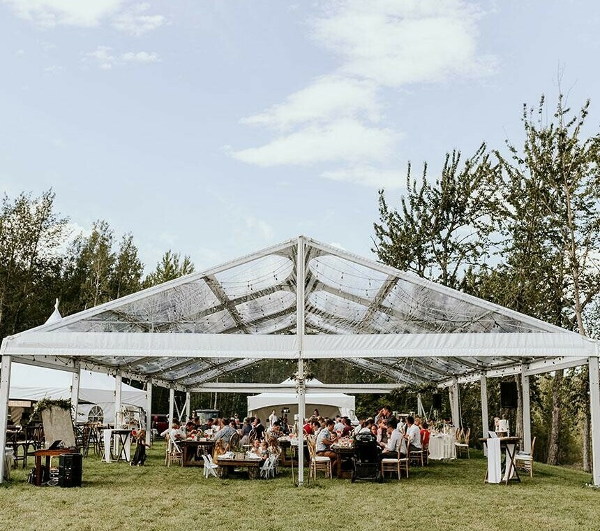 Tent Rentals Red Deer featuring the front side of a clear top Clearspan A-Frame Tent covering a wedding reception